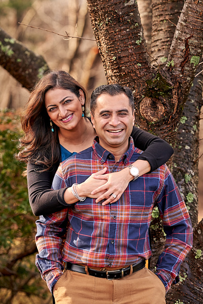 Couple standing in front of a tree