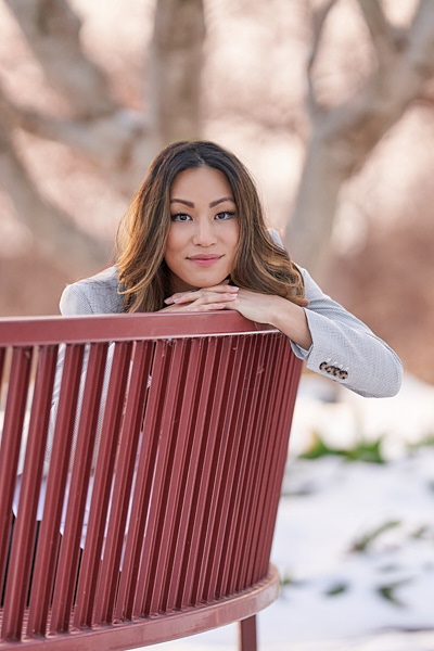 Individual Portrait of woman standing in front of purple fence